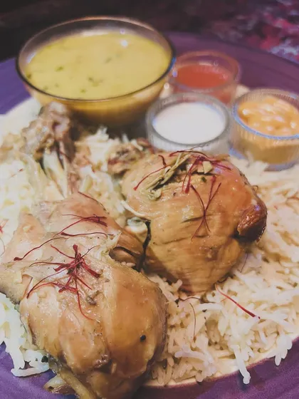 My take on Chicken Mandi Rice, featuring smoked chicken on a bed of fragrant rice, served with traditional accompaniments like tomato takkus, zaffrani shorba, and garlic mayo.