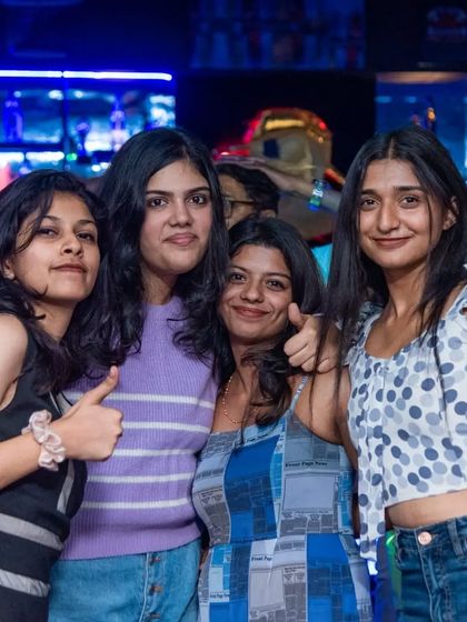 A group of friends giving a thumbs up.