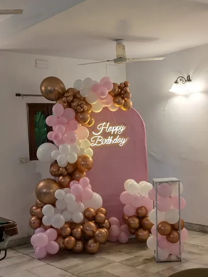 A wider view of the pink-themed birthday setup, showing how it can be placed in a living room or party space.