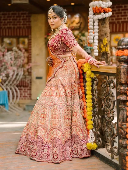 A full-length shot capturing the grandeur of a bridal lehenga. The makeup was crafted to be bold enough to stand out, yet elegant enough to feel timeless, ensuring the bride felt confident from her entrance to the final farewell.