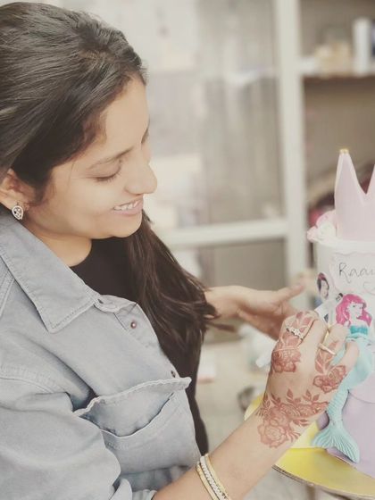 A candid shot of me adding the final details to a beautiful princess theme cake. I truly love what I do.