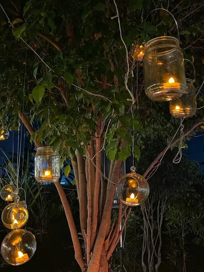 I love using these hanging glass jars and globes with candles to add a touch of rustic charm to the trees at the farm for evening events.