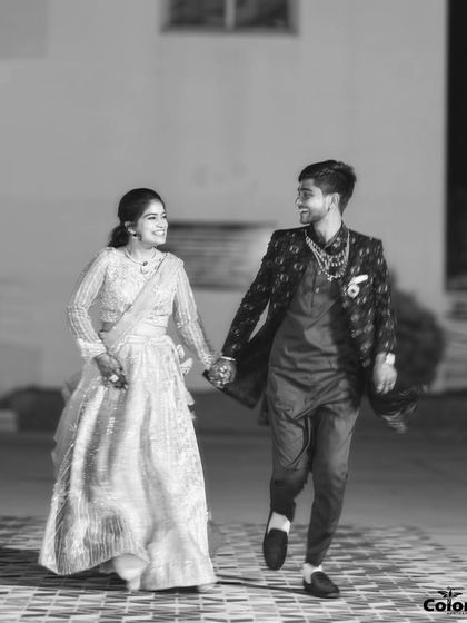 A timeless black and white shot of the couple walking hand-in-hand at night.
