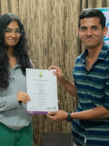 I am proud to present a student with her certificate from Trinity College London. I provide dedicated coaching to help students achieve formal qualifications from prestigious music boards.