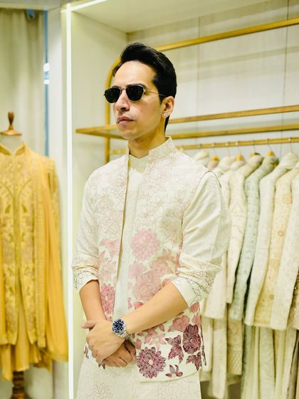 The front view of the off-white bandhgala, paired with a matching embroidered kurta underneath. The complete set is elegant and perfect for a day wedding or Mehendi.