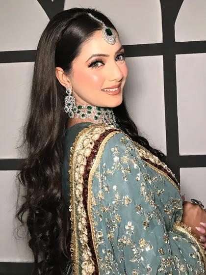 A happy, smiling client, looking absolutely radiant in her styled look.