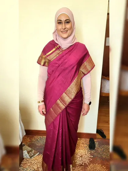 Draping a beautiful magenta silk saree while elegantly incorporating a hijab. I ensure the style is modest, comfortable, and respectful of my client's preferences.