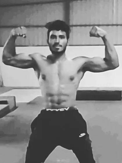 This is the result of discipline. A well-defined physique with visible abs and strong biceps, achieved through a targeted muscle gain and fat loss program.