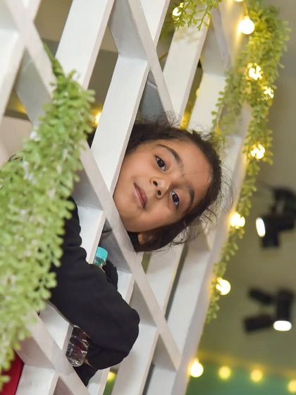 A curious peek from the window of our playhouse. The hanging vines and warm lights add to the enchanting atmosphere.