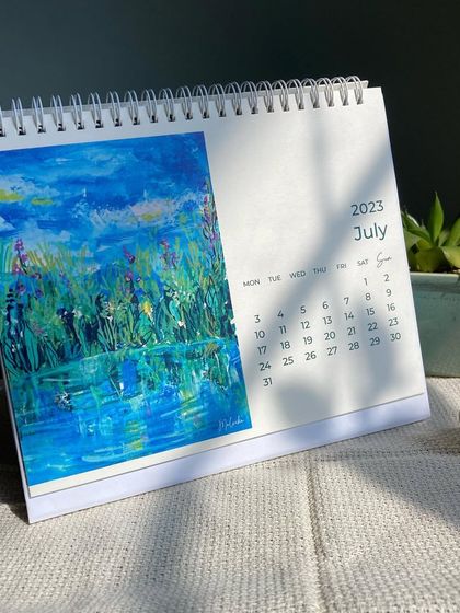 Here is the July page from my 2023 calendar. This impressionistic acrylic painting of a pond reflects the lush, vibrant greens of mid-summer.
