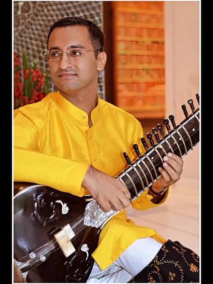 A royal look in a yellow kurta, playing Raag Shuddha Kalyan.