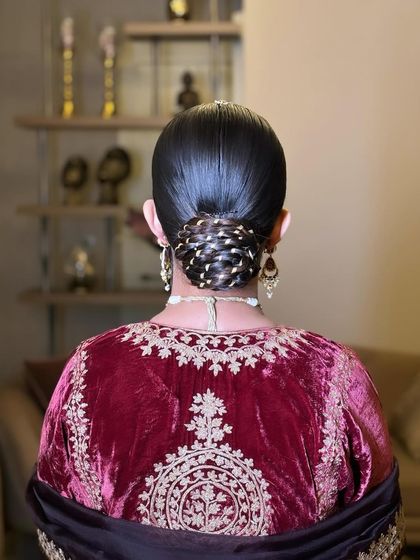 A traditional and elegant 'Gotta Bun'. I've woven golden 'gotta' or ribbon through the twists of this sleek bun, which is a classic choice for brides wearing traditional velvet or silk outfits.