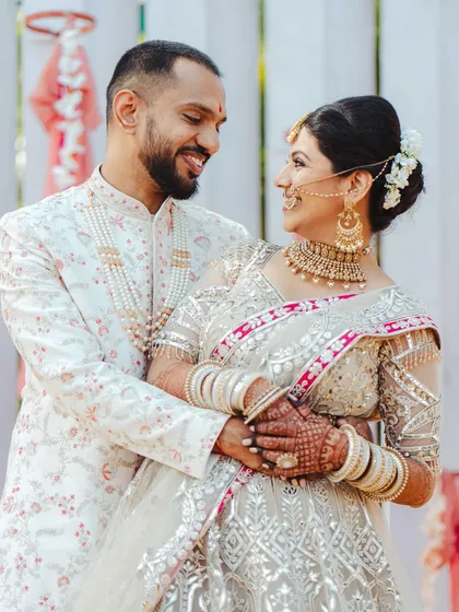 The way they look at each other says it all. This portrait of Jeenal and Chirantan is full of warmth and genuine affection, showcasing their beautiful wedding attire and the happiness of the day.