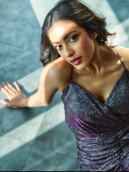 Sahher Bambba shining in this sparkly purple wrap dress. It's a perfect party-ready outfit that's all about having fun with fashion.