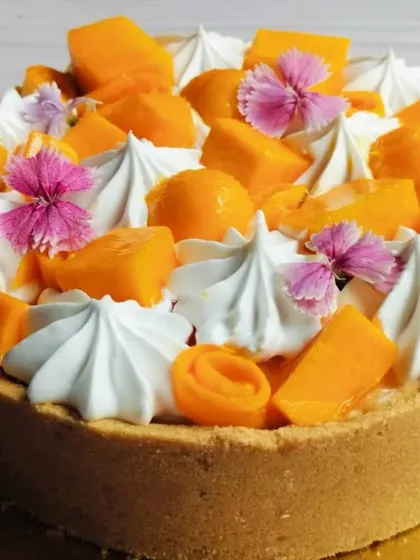 Another angle of the Mango Cheesecake, highlighting the chunks of fresh mango and delicate meringue kisses.