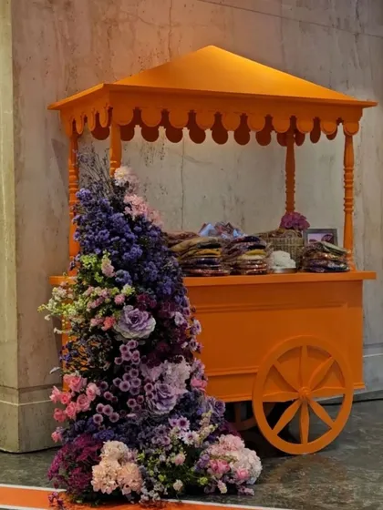 A vibrant food cart adorned with a cascade of flowers at Aadar Jain and Alekha Advani’s Sangeet Mehendi. This setup served as a beautiful and interactive focal point for guests.