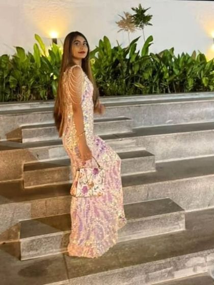 The full look, complete with a matching handbag. This custom sequin gown was designed to shine from every angle.