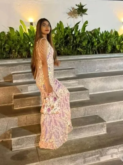The full look, complete with a matching handbag. This custom sequin gown was designed to shine from every angle.