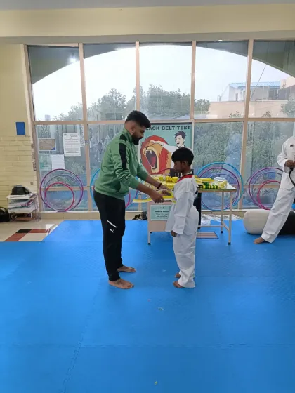 Tying a yellow belt.