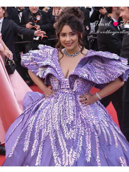 A candid moment on the Cannes red carpet. The layered diamond necklace and bold blue sapphire ring add a touch of modern luxury to this fairytale gown, showcasing how I style high-fashion events.