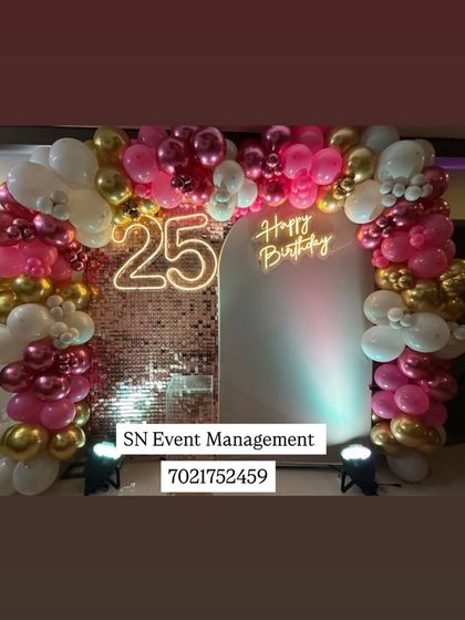 A beautiful sequin wall decoration for a 25th birthday. The arch is made of pink, white, and gold chrome balloons, with a neon number '25' and a "Happy Birthday" sign.