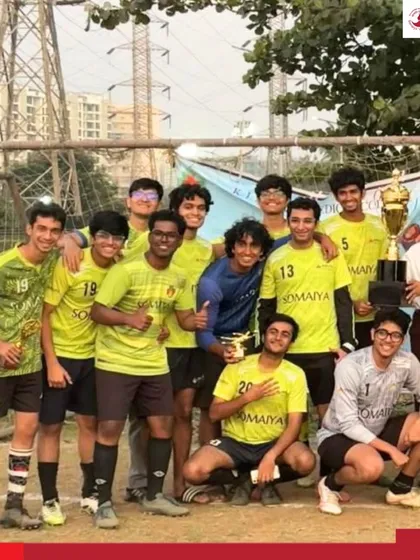 The entire team celebrates their championship win at the Vanquish 2026 football tournament, posing with their trophy.