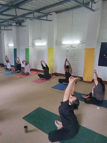 An indoor session at our yoga retreat, focusing on seated side stretches. Even when we practice indoors, the energy of the group and the focused intention remain powerful.