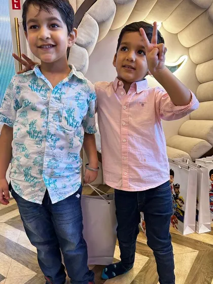 We meticulously plan every party so the entire family feels special. This photo of two young friends captures the simple joy and connection that makes these events magical.