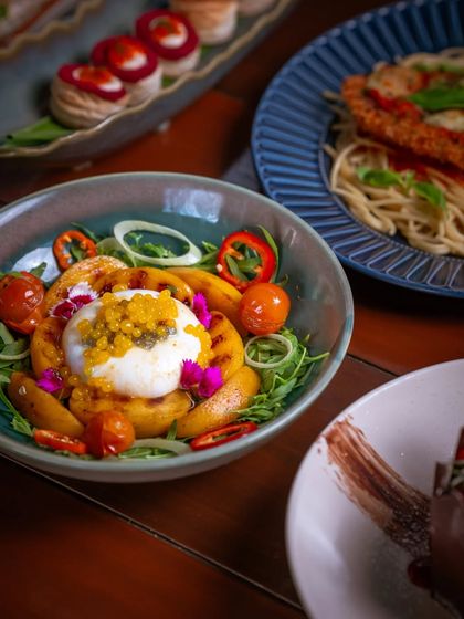 A festive holiday spread, featuring a beautiful burrata salad and other delights, crafted to bring people closer.