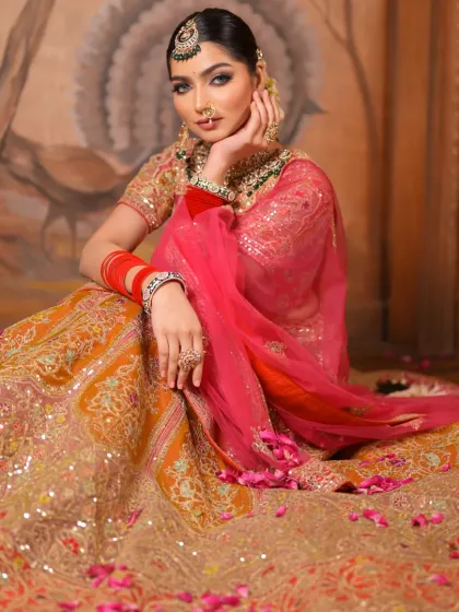 A wide shot showing the bride seated, with her magnificent lehenga spread around her. Her makeup is designed to make her the undeniable center of attention.