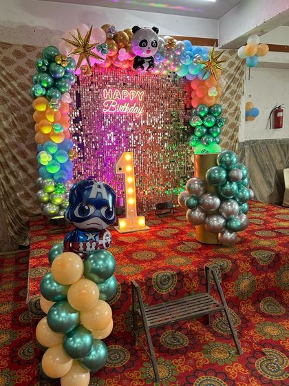 Another view of the colorful first birthday, showing the Captain America balloon figure.