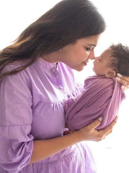 A tender nose-to-nose moment between a mother and her baby. The soft lavender colors and gentle light make this a truly sweet and loving portrait.