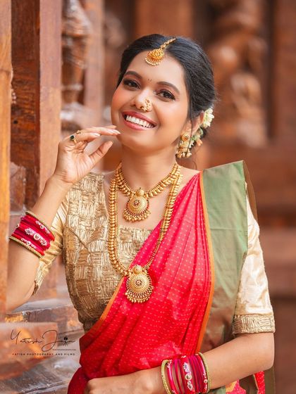 A close-up of the festive South Indian look. Note the traditional bindi, radiant skin, and how the makeup complements the beautiful gold jewellery.