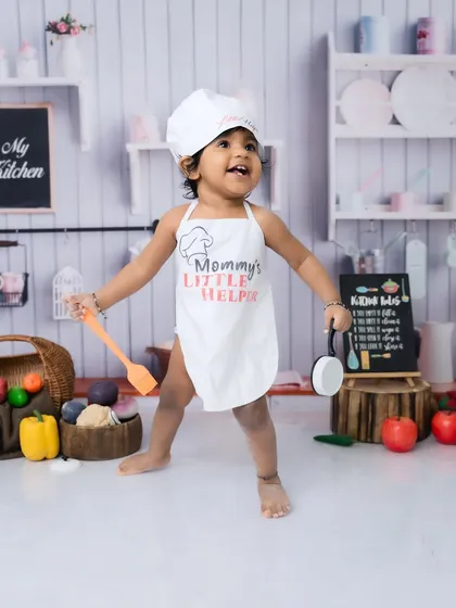 Standing tall and ready to cook! The "Mommy's Little Helper" apron adds such a sweet touch to this toddler chef theme.