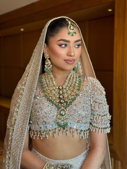 The perfect modern bride. This shot shows how the sleek ponytail and sharp makeup create a chic and contemporary bridal look.