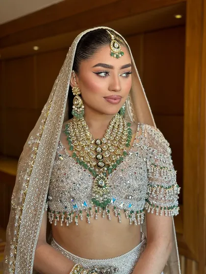 The perfect modern bride. This shot shows how the sleek ponytail and sharp makeup create a chic and contemporary bridal look.