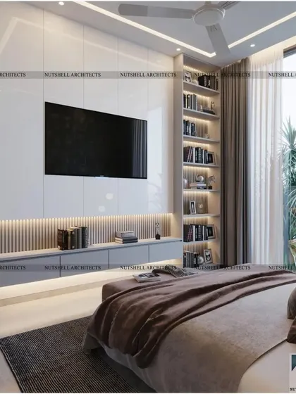 A modern and minimal bedroom design where functionality is key. The TV is mounted on a high-gloss white panel, with a floating console and a full-height bookshelf that provides ample storage and display space.