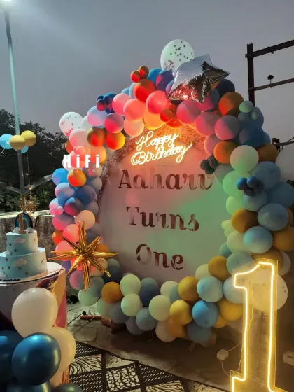 The outdoor birthday setup under warm, colorful lighting.