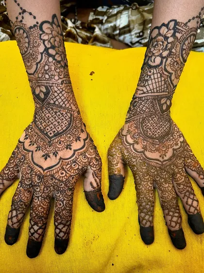 A beautiful example of a semi-bridal or guest mehendi in a traditional style. The design features classic cuff patterns and a detailed palm.