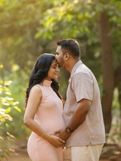 A tender kiss on the forehead is a classic for a reason. It's a simple, beautiful gesture of love, made even more magical by the soft outdoor light.
