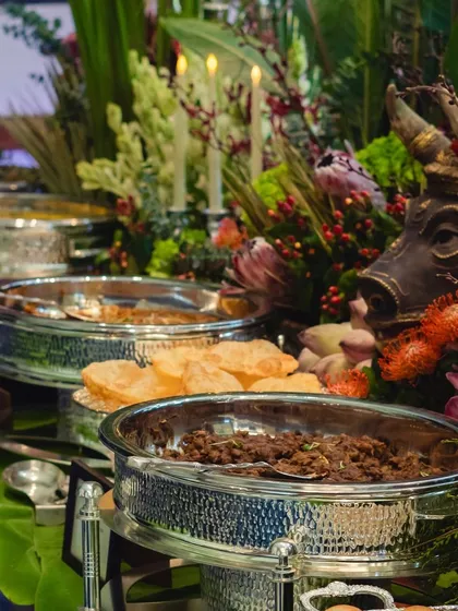 Our buffet stations are a feast for the senses. Here, traditional Indian dishes are presented in magnificent hammered silver serveware, nestled amongst dramatic floral and decorative elements.
