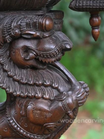 A close-up of the Yaazhi's head, showing the texture and finish of the polished wood.