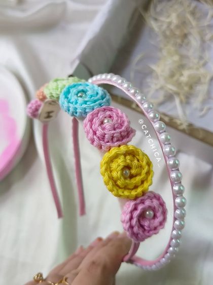 Our floral tiara with a pearl hairband is so pretty for little ones. This one has pastel crochet flowers and is paired with a pearl-lined band for extra elegance.