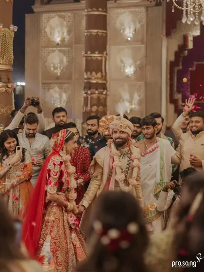 Walking together amidst their loved ones. This shot captures the energy and joy of the celebration as guests shower the couple with petals, a moment of collective blessing that I love to facilitate.