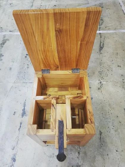 A top-down view of the open coconut grater, showing the layout and construction of the interior.