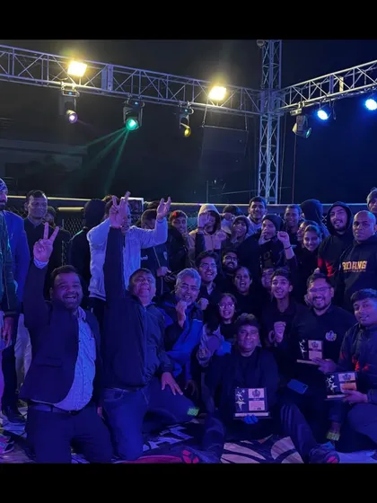 The entire team of officials celebrating a successful event at Elite Combat MMA.