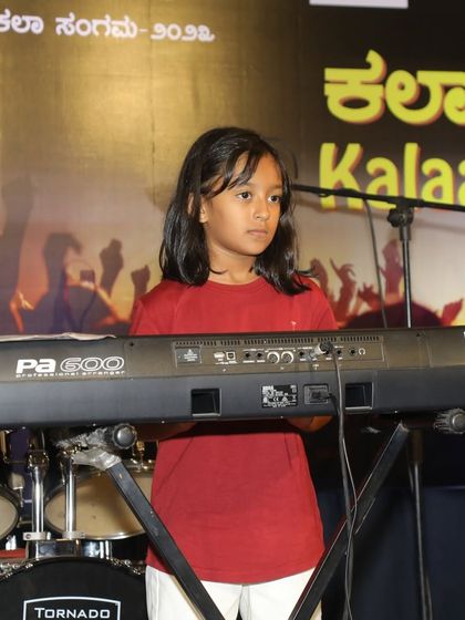 A student at her Korg keyboard during the 'Vande Mataram' tribute.