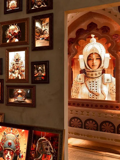 We delve into the visual culture of Indofuturism, blending familiar Indian landscapes with retro-futuristic narratives. This installation juxtaposes a hybrid futuristic portrait, presented within a traditional Indian Mahal archway, against a backdrop of AI-generated imagery. It is a dialogue between craft and technology, east and west, the old and the new.