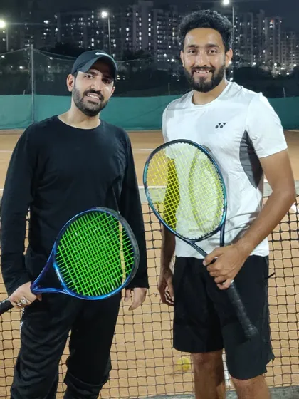 Another shot of our head coach with a student from our adult program. We provide a supportive environment for adults to learn, improve their fitness, and enjoy the game of tennis.