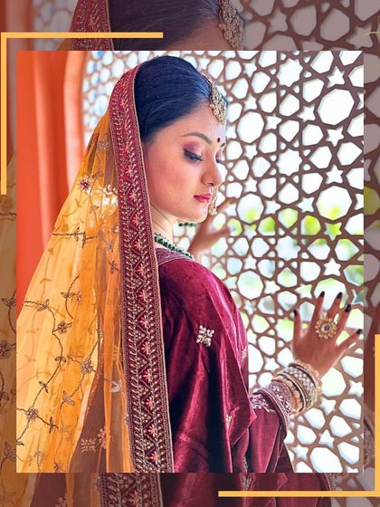 A side profile showcasing the beautiful drape of the dupatta and the intricate work on the velvet blouse of this bridal lehenga.